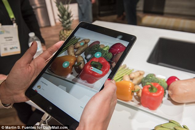 Yummly has unveiled a new app at CES that can scan the items in your fridge and recommend recipes based on what you have, even taking your preferences and dietary restrictions into account. Above, it can be seen scanning and labeling each food item on the table