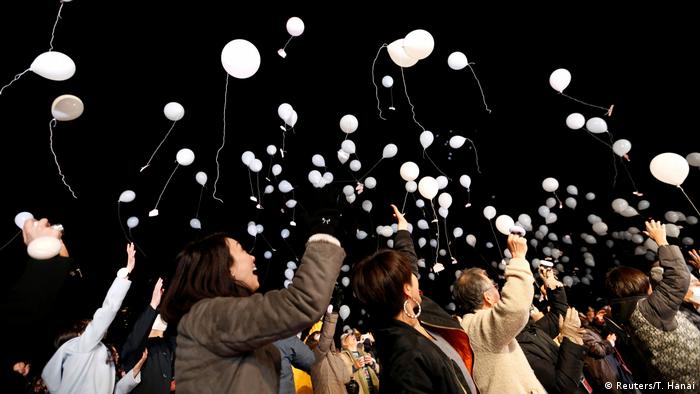 People release balloons as part of a New Year countdown event in Tokyo